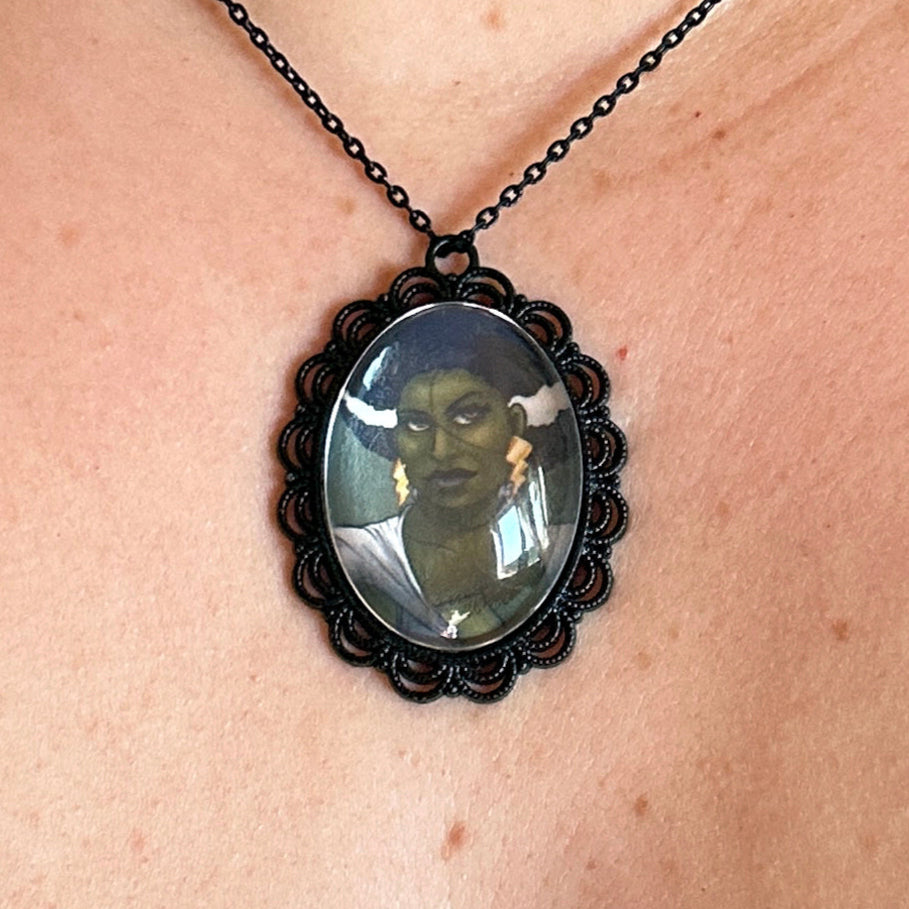 Necklace with a pendant featuring a portrait on a person's neck.